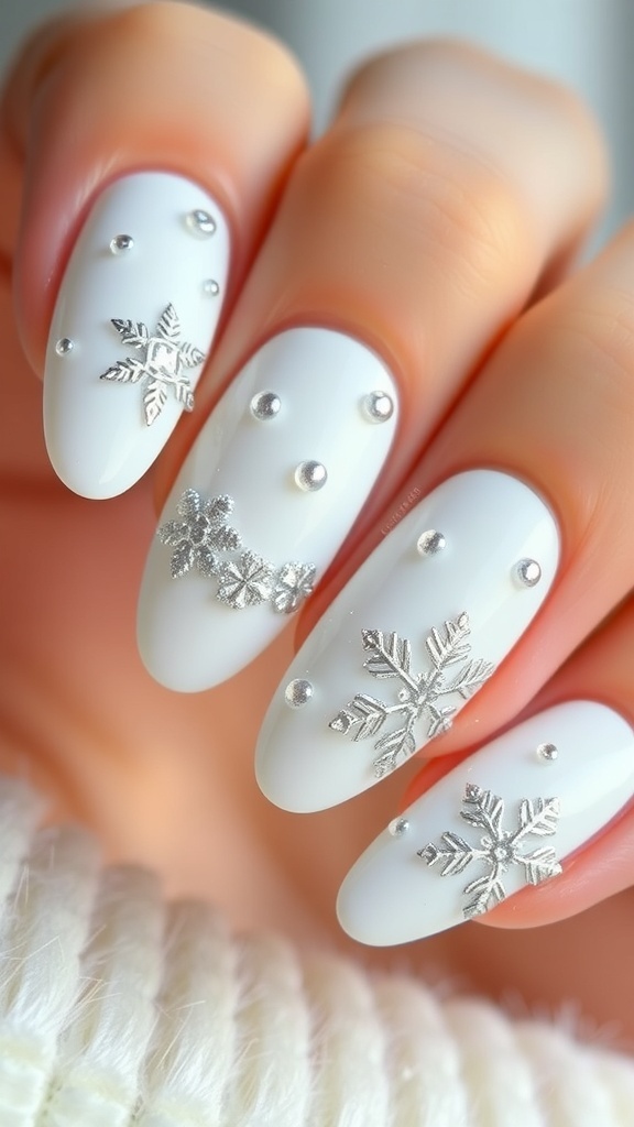 Elegant white and silver Christmas nail art with snowflakes and glitter.